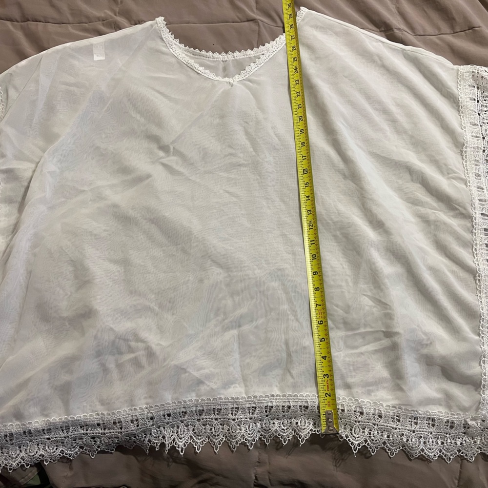 Sheer light weight poncho or bathing suit cover up with lace trim
